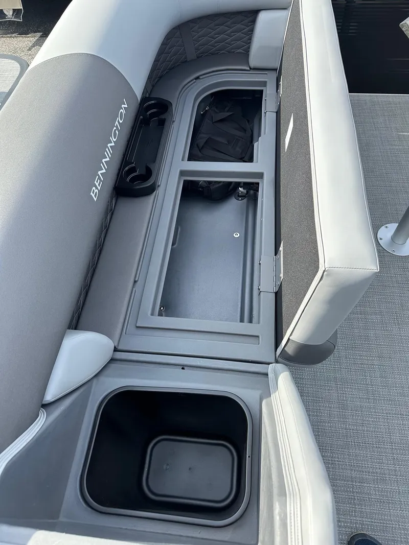 Slide: The Image of 2024 Bennington 20 SSR Quad Bench with open storage compartments. - 6
