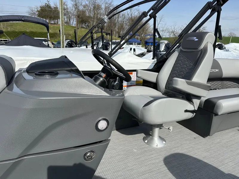 Slide: The Image of 2024 Bennington 20 SSR Quad Bench boat interior with steering console and seating. - 7