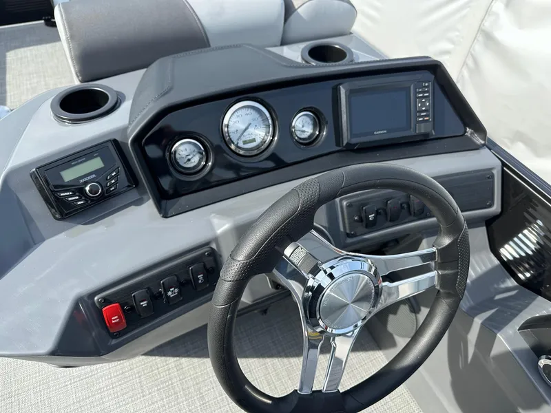 Slide: The Image of 2024 Bennington 20 SSR Quad Bench dashboard with steering wheel and control panel. - 9