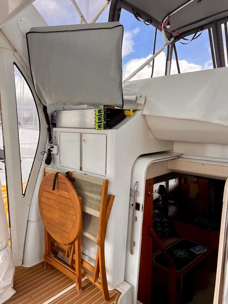 Slide: The Image of 2000 Carver 396 Motor Yacht interior with foldable table and storage cabinets. - 13