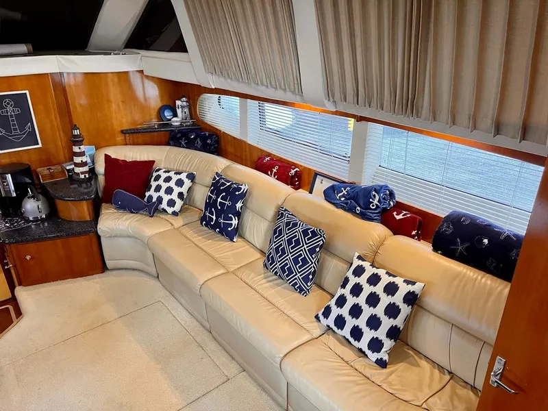 Slide: The Image of Interior of 2000 Carver 396 Motor Yacht with nautical-themed pillows and decor. - 17