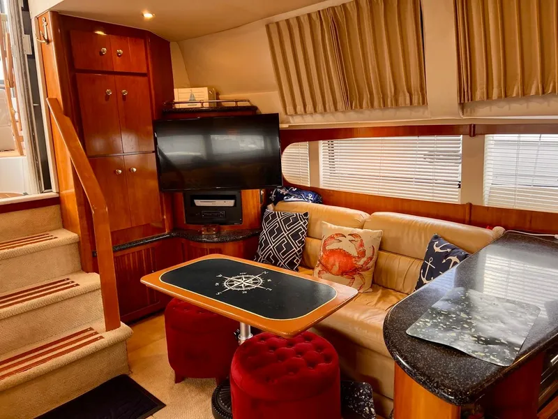 Slide: The Image of Interior of 2000 Carver 396 Motor Yacht with cozy seating, TV, and nautical-themed decor. - 18
