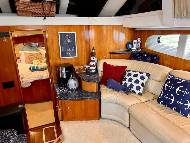 Slide: The Image of Interior of 2000 Carver 396 Motor Yacht with nautical decor and cozy seating area. - 20
