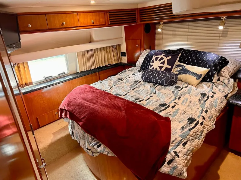 Slide: The Image of Luxurious bedroom in a 2000 Carver 396 Motor Yacht with cozy bedding and nautical decor. - 28