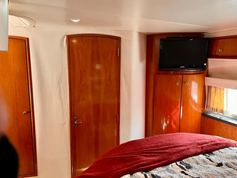 Slide: The Image of Interior cabin of 2000 Carver 396 Motor Yacht with TV and wooden doors. - 30