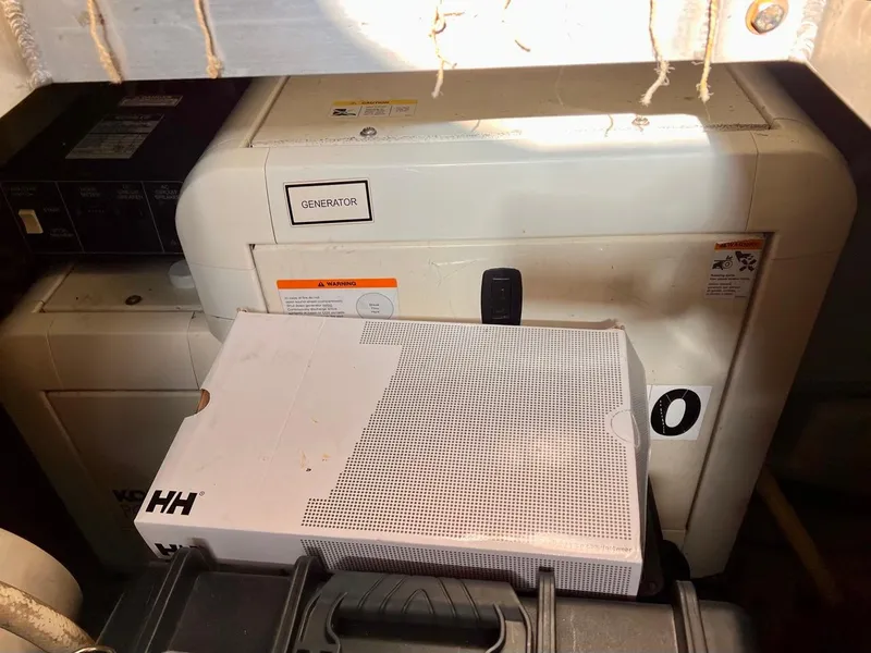 Slide: The Image of Generator compartment of a 2000 Carver 396 Motor Yacht with storage boxes. - 34