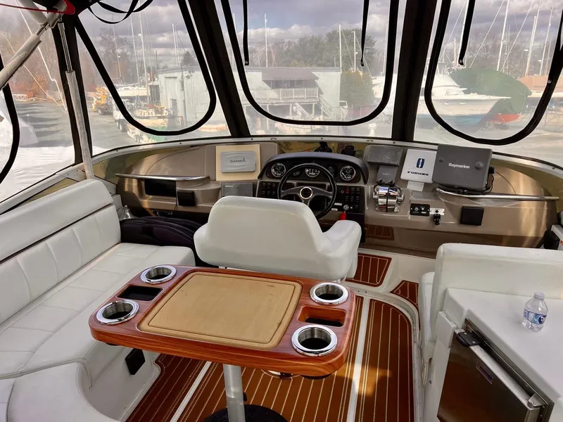 Slide: The Image of Interior of 2000 Carver 396 Motor Yacht helm with seating and control panel. - 7