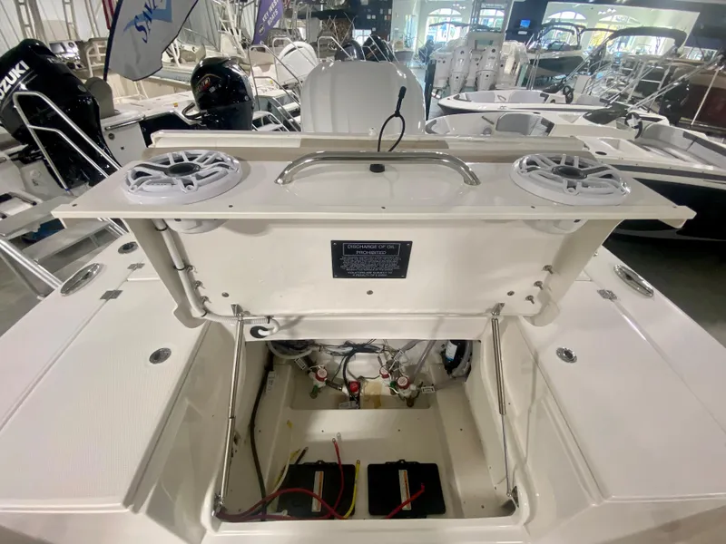 Slide: The Image of 2026 Robalo 246 Cayman boat interior, showcasing storage compartment and equipment. - 12