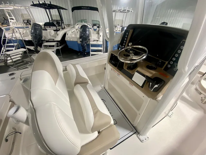 Slide: The Image of 2026 Robalo 246 Cayman boat interior with modern helm and seating. - 14