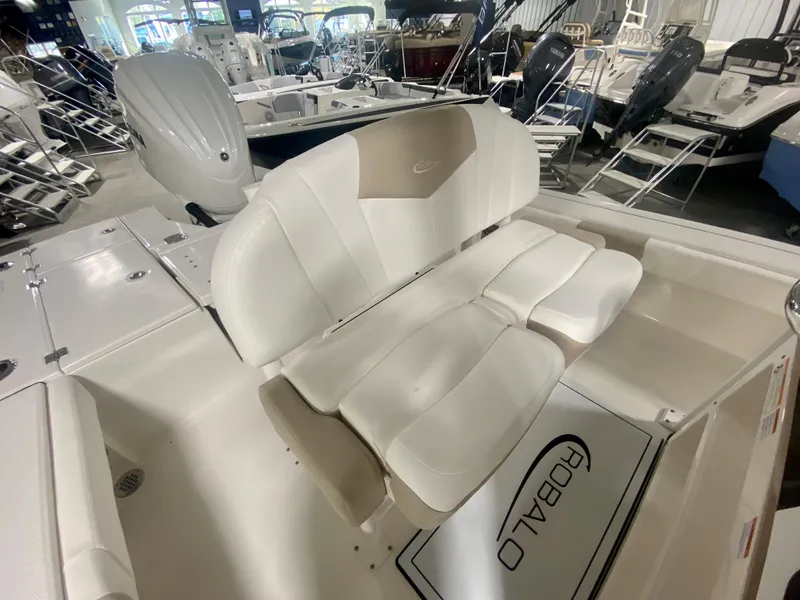 Slide: The Image of 2026 Robalo 246 Cayman boat interior with white seating and logo. - 16