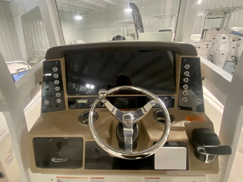 Slide: The Image of 2026 Robalo 246 Cayman boat dashboard with steering wheel and control panel. - 17