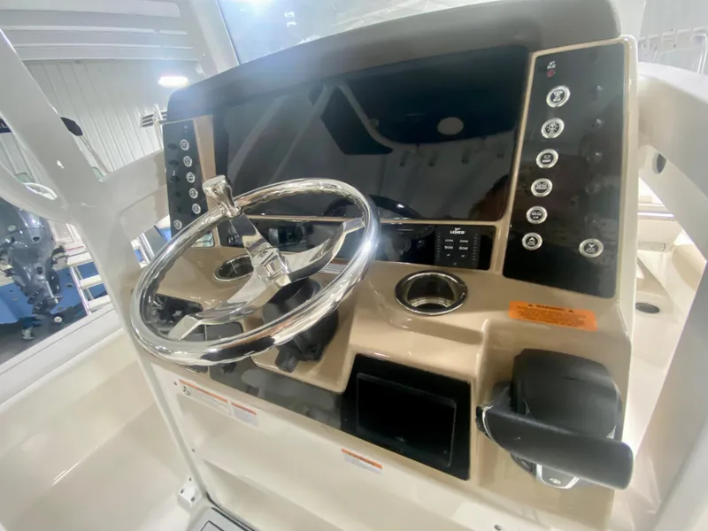 Slide: The Image of 2026 Robalo 246 Cayman boat dashboard with steering wheel and control panel. - 18