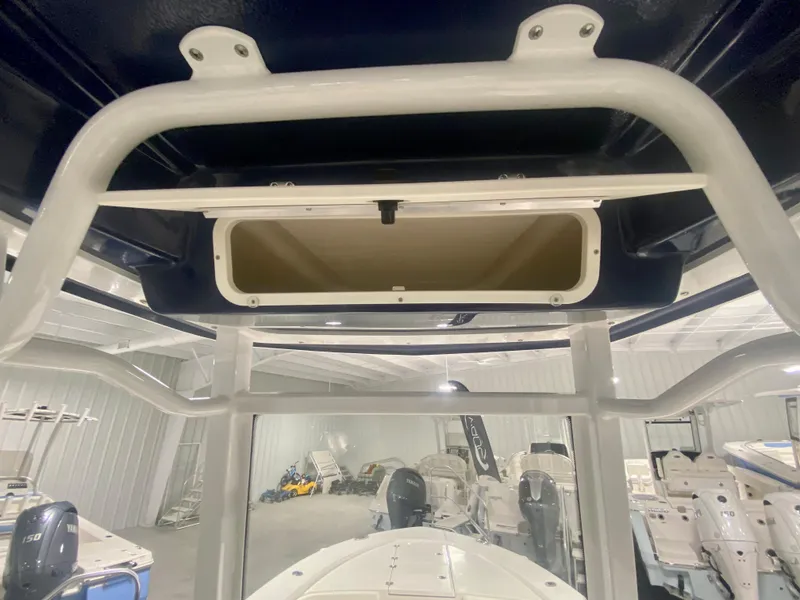 Slide: The Image of 2026 Robalo 246 Cayman boat interior with storage compartment and visible framework. - 19