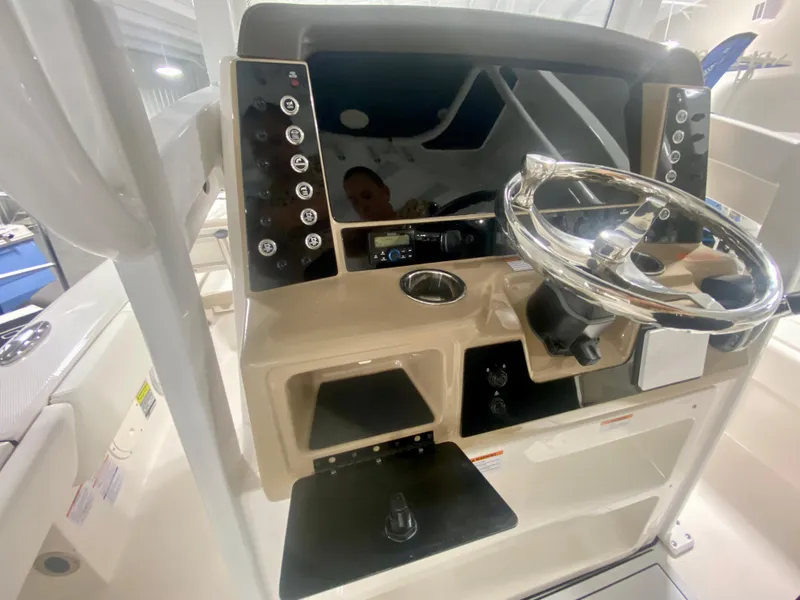 Slide: The Image of 2026 Robalo 246 Cayman boat dashboard with steering wheel and control panel. - 20