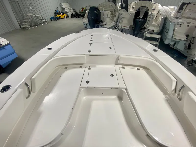 Slide: The Image of 2026 Robalo 246 Cayman boat interior with spacious seating and storage compartments. - 24