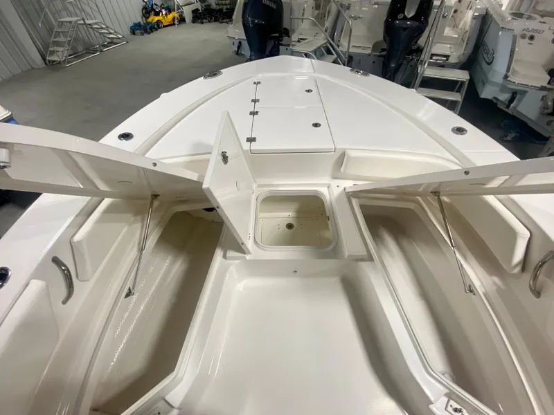 Slide: The Image of 2026 Robalo 246 Cayman boat interior with open storage compartments. - 25