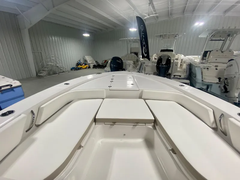 Slide: The Image of 2026 Robalo 246 Cayman boat interior in showroom, featuring spacious seating and sleek design. - 27