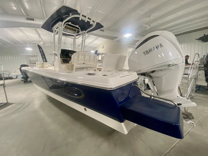 Slide: The Image of 2026 Robalo 246 Cayman boat with Yamaha engine in indoor showroom. - 3
