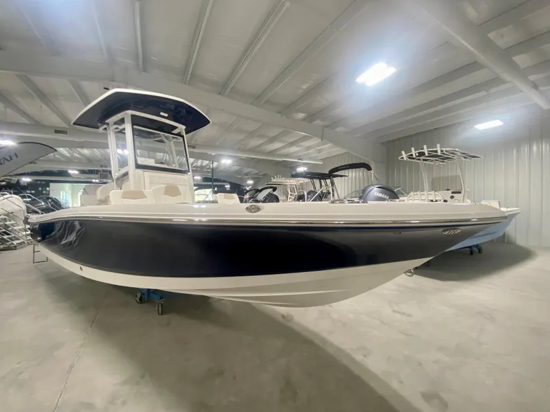 Slide: The Image of 2026 Robalo 246 Cayman boat in showroom, featuring sleek design and modern amenities. - 5