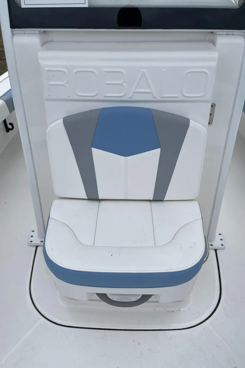 Slide: The Image of Robalo 246 Cayman 2026 boat seat with blue and gray accents. - 9
