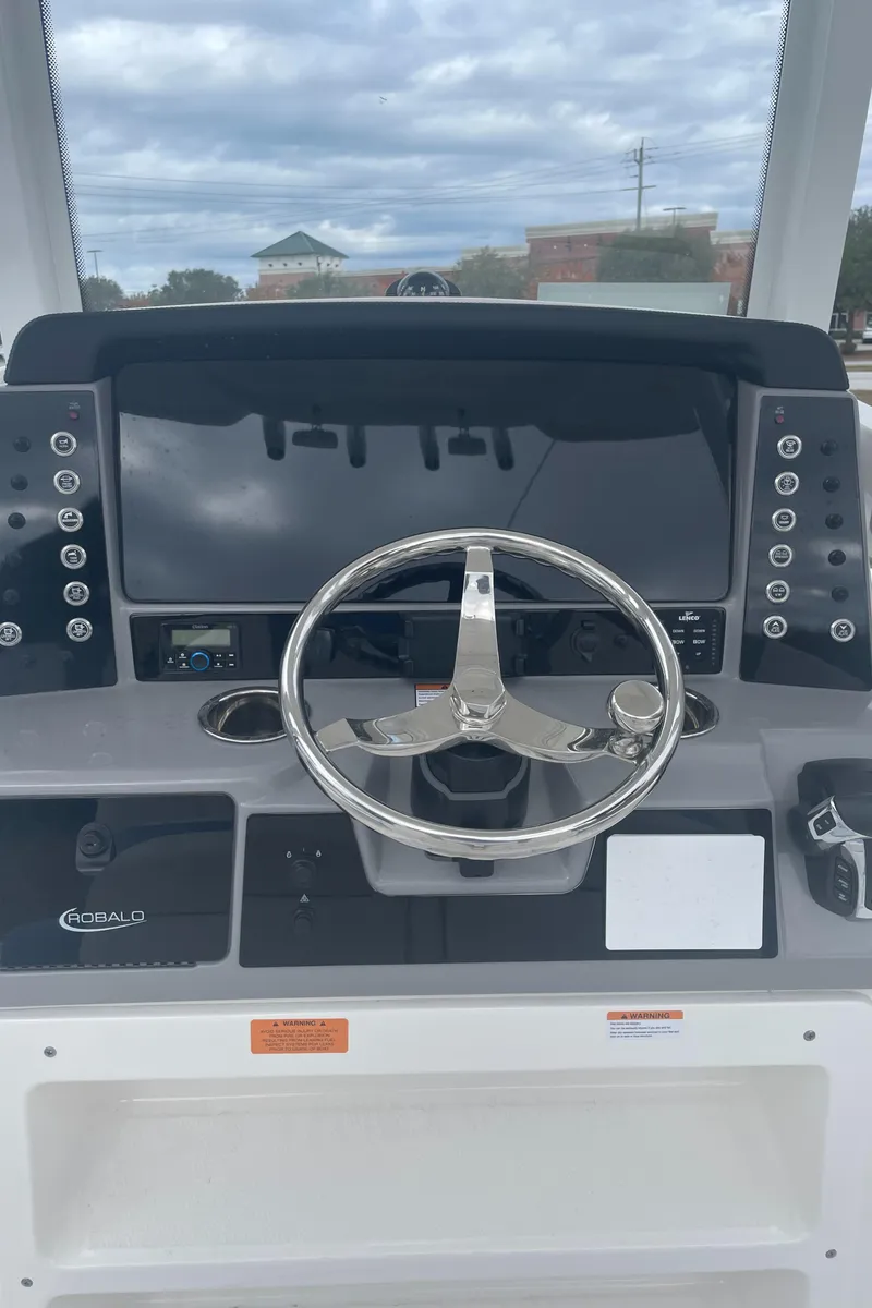 Slide: The Image of 2026 Robalo 246 Cayman boat dashboard with steering wheel and control panel. - 8