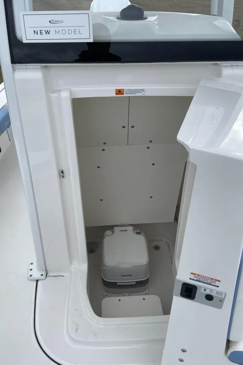 Slide: The Image of 2026 Robalo 246 Cayman boat interior with compact storage compartment. - 10