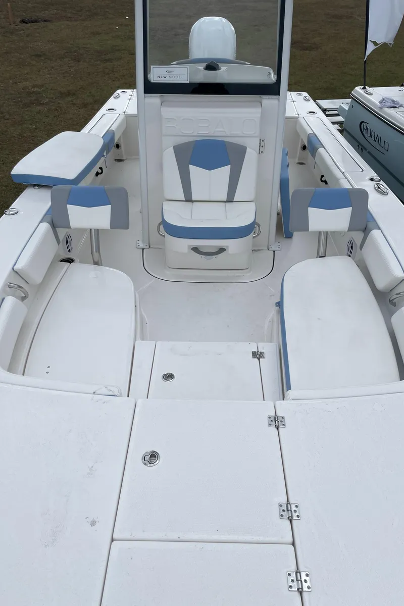 Slide: The Image of 2026 Robalo 246 Cayman boat interior with white and blue seating. - 11