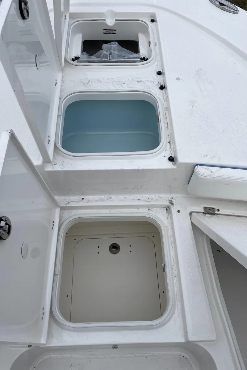 Slide: The Image of 2026 Robalo 246 Cayman boat storage compartments and livewell, showcasing spacious and organized design. - 16