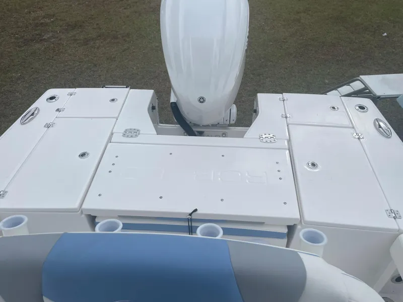 Slide: The Image of 2026 Robalo 246 Cayman boat deck with storage compartments and motor. - 3