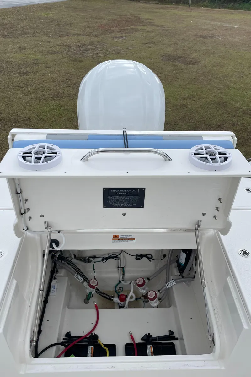 Slide: The Image of 2026 Robalo 246 Cayman boat with open storage compartment and speakers. - 5