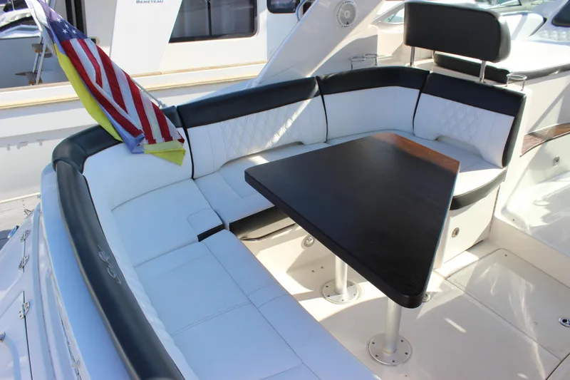 Slide: The Image of 2014 Sea Ray 350 Sundancer boat interior with seating and table. - 12