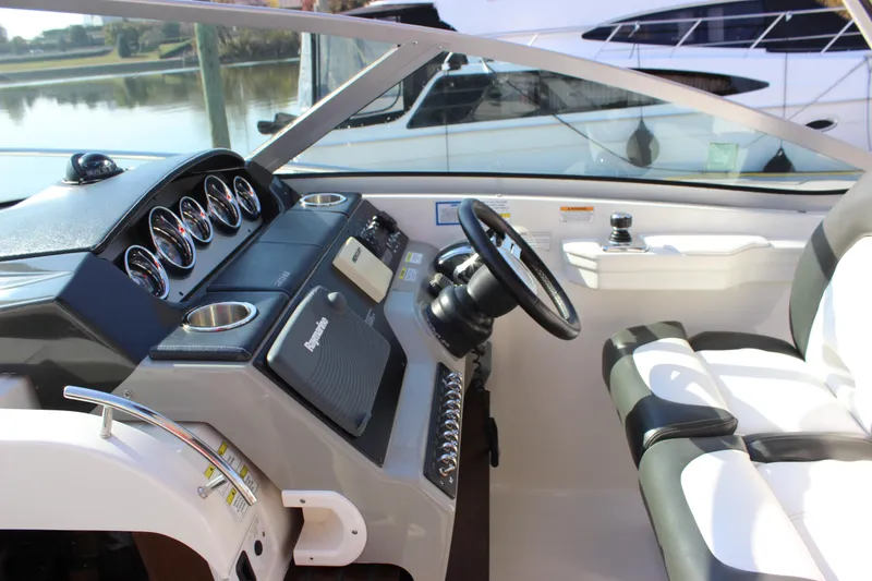 Slide: The Image of Interior helm of 2014 Sea Ray 350 Sundancer with steering wheel and gauges. - 18