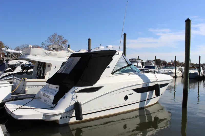 Slide: The Image of 2014 Sea Ray 350 Sundancer yacht docked at marina. - 2
