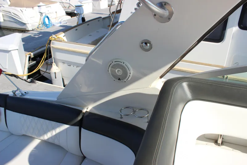 Slide: The Image of 2014 Sea Ray 350 Sundancer interior with seating and speaker detail. - 21