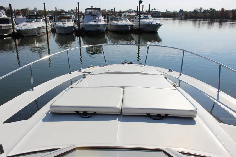Slide: The Image of 2014 Sea Ray 350 Sundancer yacht docked in a marina, featuring spacious sunbathing deck. - 29