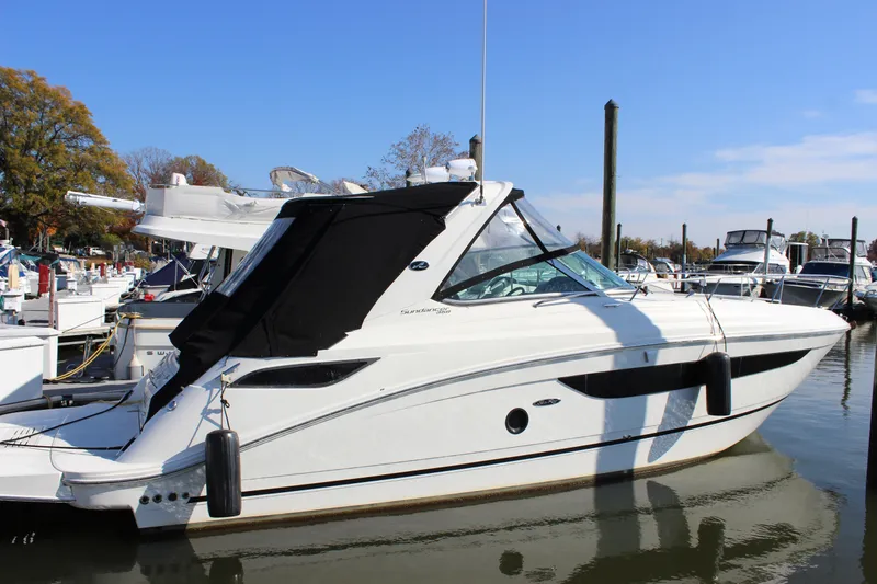 Slide: The Image of 2014 Sea Ray 350 Sundancer docked at marina, side view. - 3