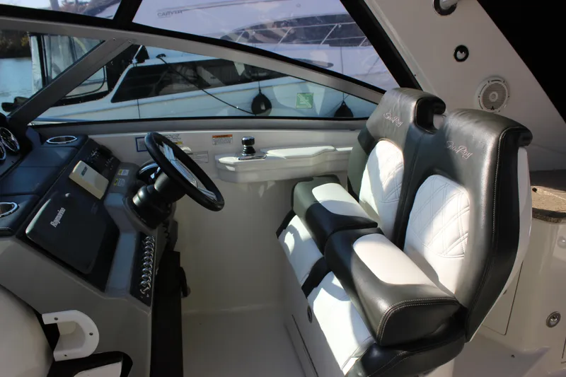 Slide: The Image of Interior cockpit of 2014 Sea Ray 350 Sundancer with dual black and white seats. - 33