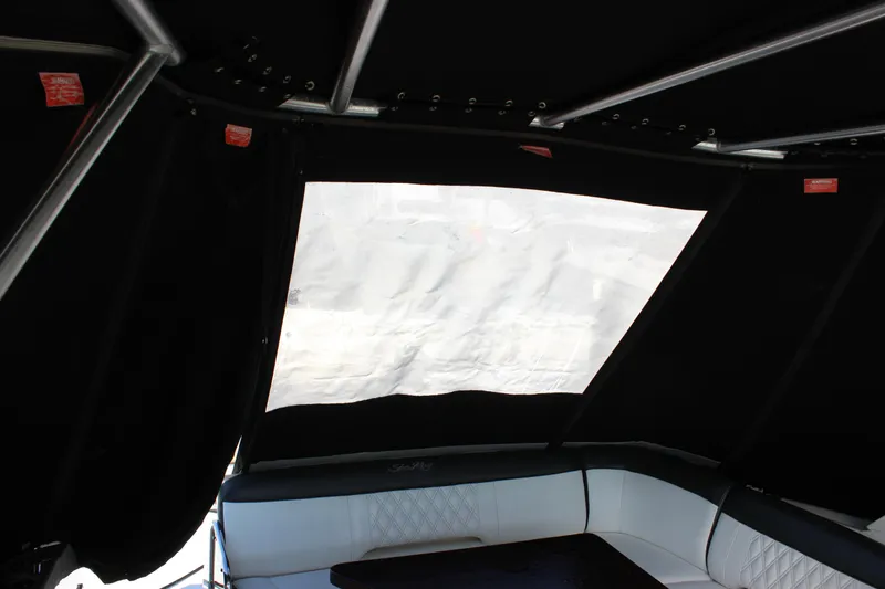 Slide: The Image of Interior view of 2014 Sea Ray 350 Sundancer with black canopy and white seating. - 36