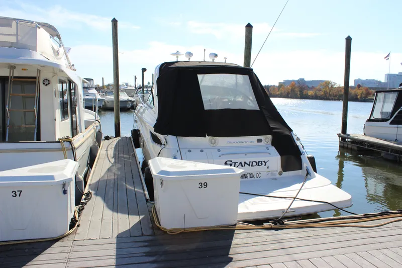 Slide: The Image of 2014 Sea Ray 350 Sundancer docked at marina, rear view with black cover. - 4