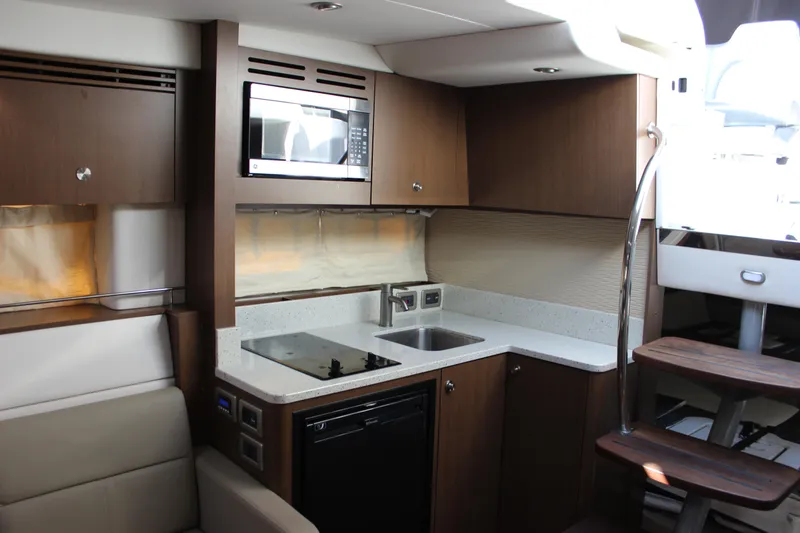 Slide: The Image of 2014 Sea Ray 350 Sundancer yacht interior with modern kitchen and wooden cabinetry. - 41
