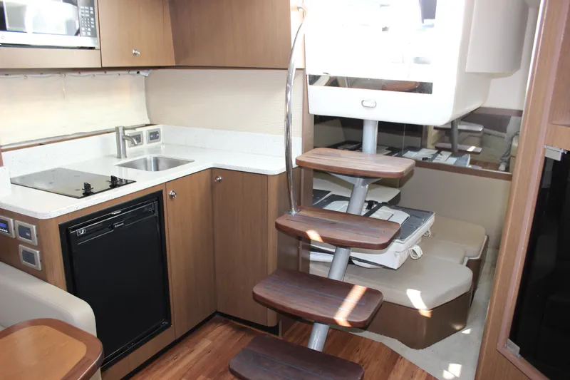 Slide: The Image of Interior of 2014 Sea Ray 350 Sundancer yacht with modern kitchen and wooden stairs. - 42