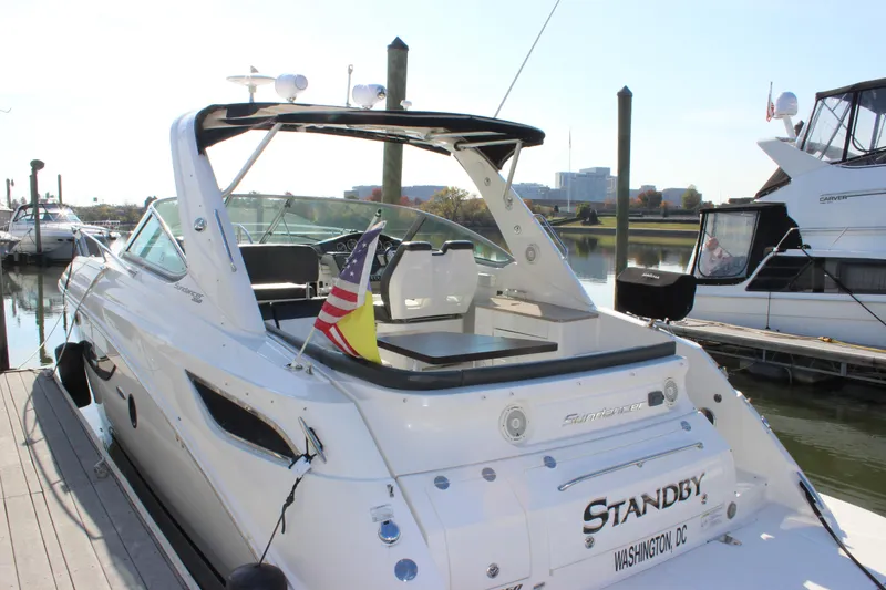 Slide: The Image of 2014 Sea Ray 350 Sundancer docked, rear view with flags, Washington D.C. - 8