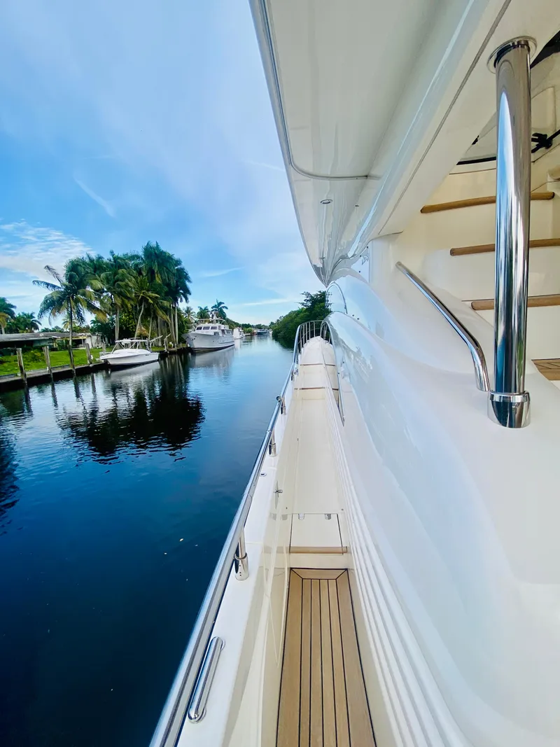 Slide: The Image of 2006 Viking Sport Cruisers 70 Motor Yacht docked by a serene waterway. - 17