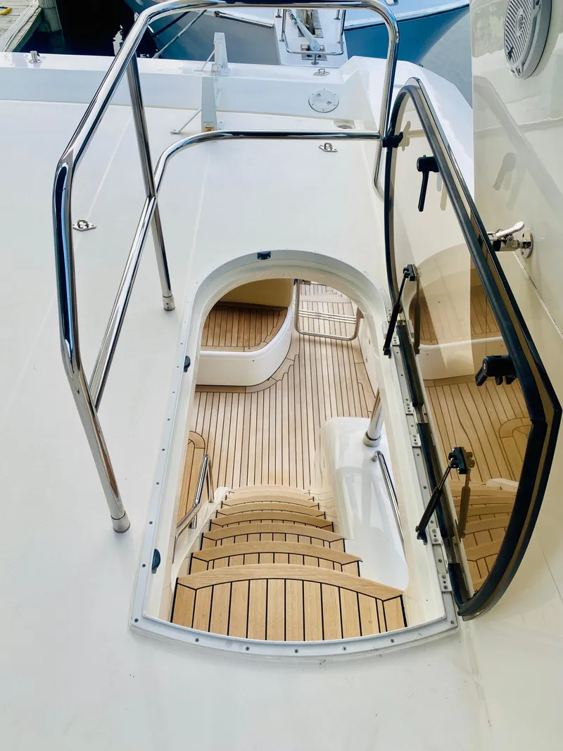 Slide: The Image of Staircase on 2006 Viking Sport Cruisers 70 Motor Yacht with teak flooring. - 20