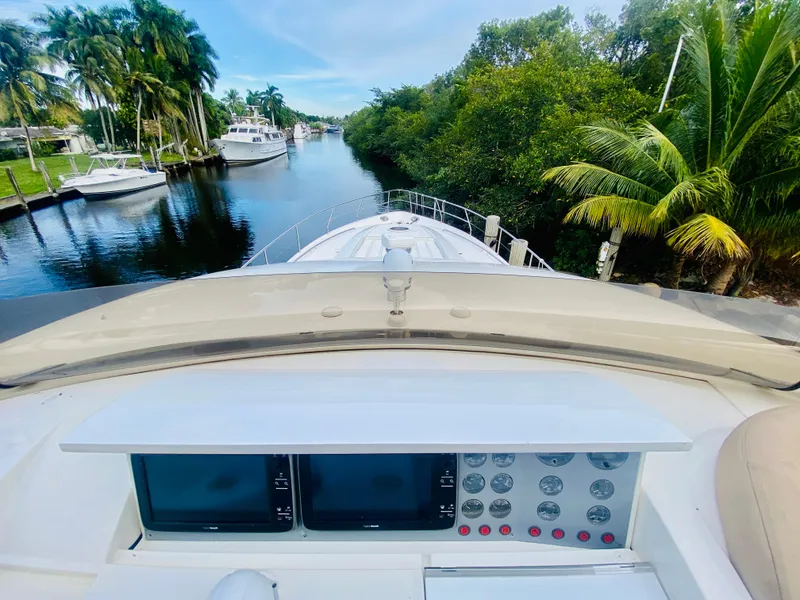 Slide: The Image of 2006 Viking Sport Cruisers 70 Motor Yacht navigating a serene, tropical waterway. - 21