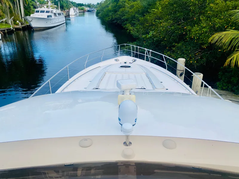 Slide: The Image of 2006 Viking Sport Cruisers 70 Motor Yacht on a serene waterway. - 22