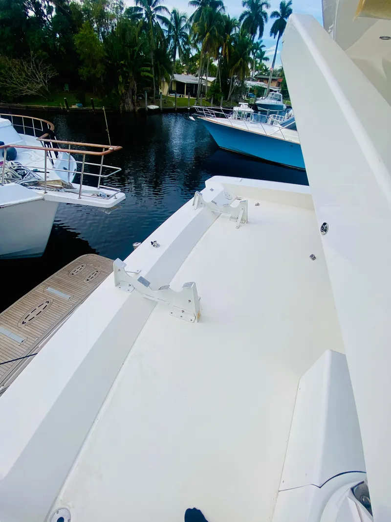 Slide: The Image of 2006 Viking Sport Cruisers 70 Motor Yacht docked near other boats. - 24