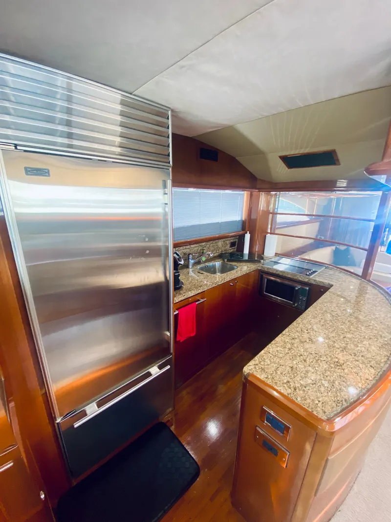 Slide: The Image of 2006 Viking Sport Cruisers 70 Motor Yacht kitchen with granite countertops and stainless steel appliances. - 37
