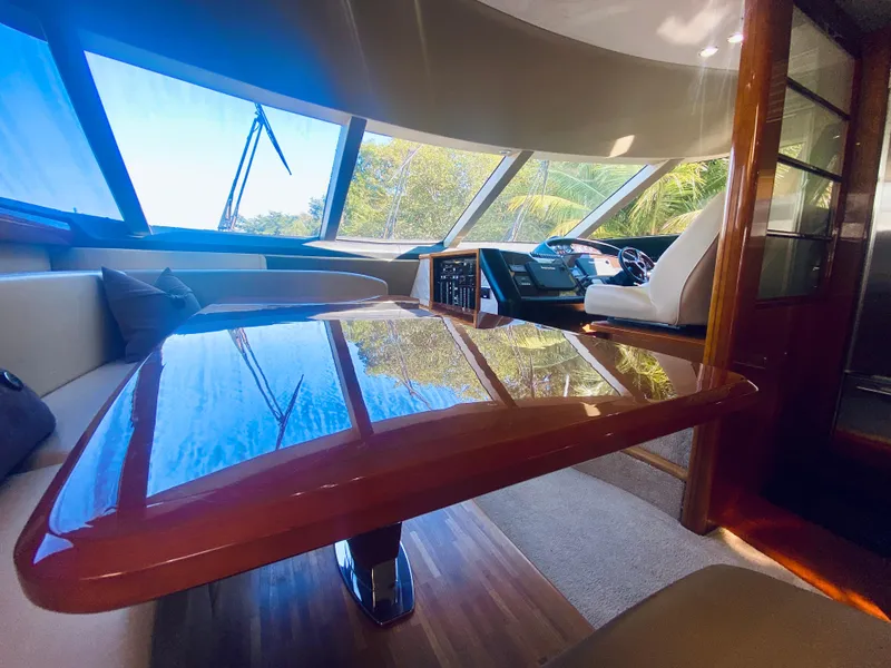 Slide: The Image of Interior of 2006 Viking Sport Cruisers 70 Motor Yacht with polished wooden table. - 41