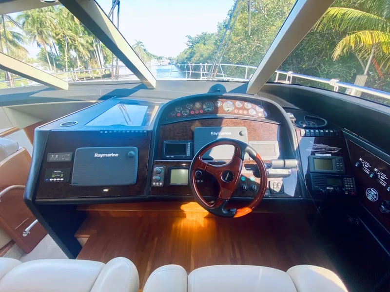 Slide: The Image of Helm of 2006 Viking Sport Cruisers 70 Motor Yacht with navigation equipment and wooden steering wheel. - 46